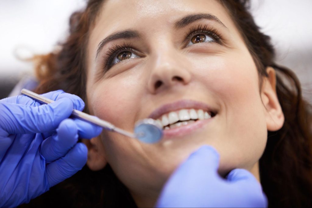 smiling woman receiving dental care